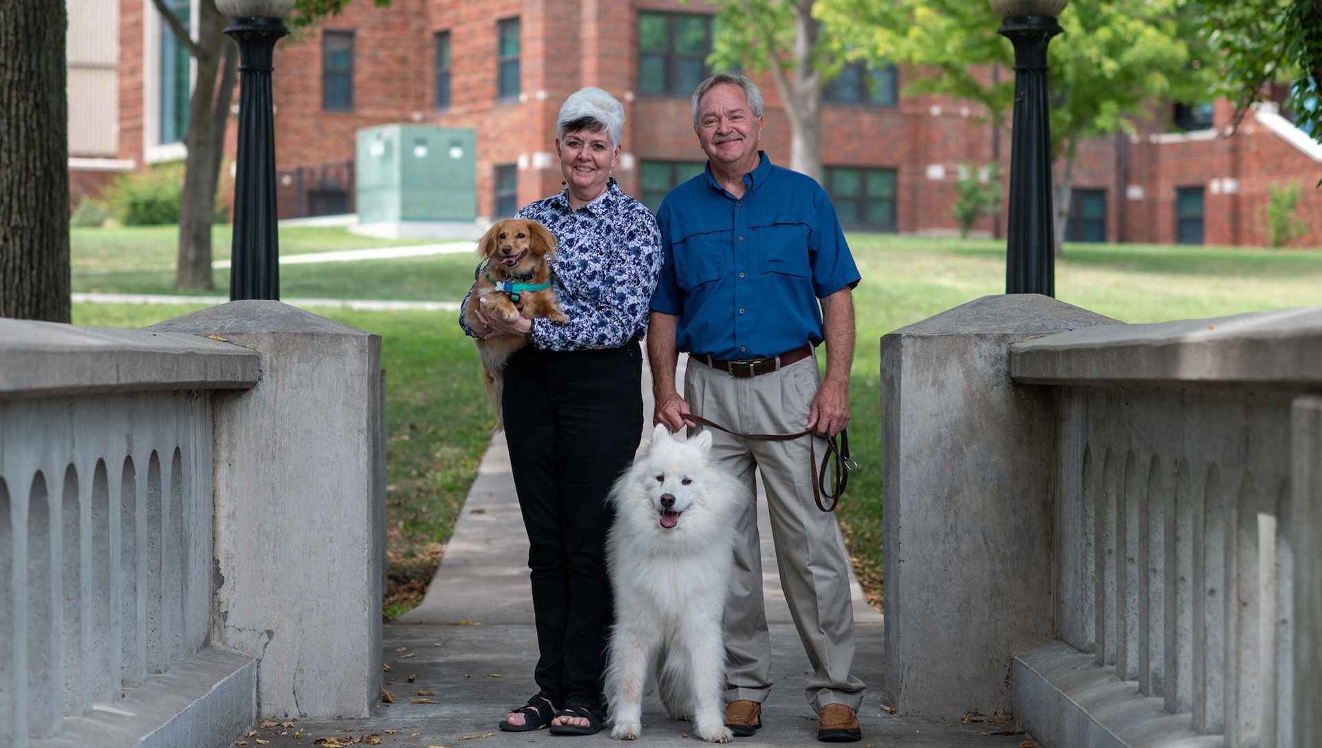 Couple posing with two dogs
